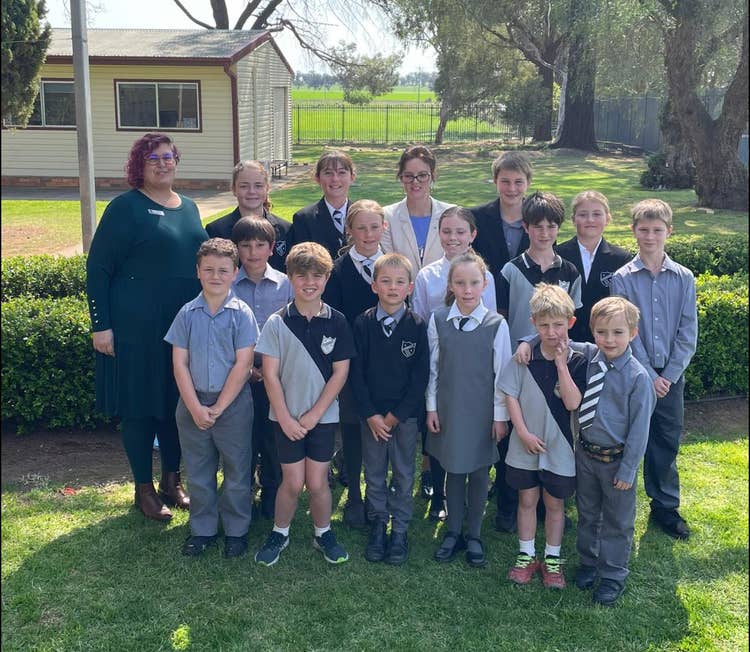 Amanda Morton standing with staff members and children